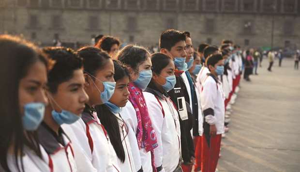 A group of students wear face masks during a ceremony at Zocalo Square in Mexico City on Friday.