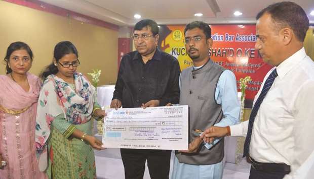 Mita Santra (second left), wife of CRPF trooper Bablu Santra receives a cheque of Rs101,000 during an event by Siliguri Taxation Bar Association in Siliguri, West Bengal, yesterday. The association organised the event to donate Rs101,000 each the families of the CRPF personnel killed in a deadly attack on a convoy in Kashmir on February 14.