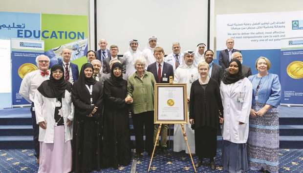 HE the Minister of Public Health Dr Hanan Mohamed al-Kuwari and other officials with the JCI accreditation plaque for the 13 facilities and services of HMC.
