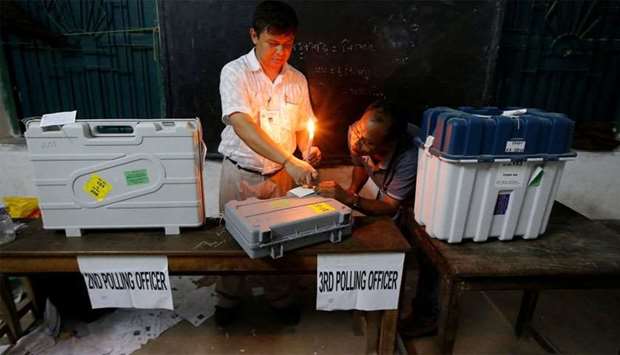Polling officials seal EVM and VVPAT machines at a polling station after the end of the last phase of the general election in Kolkata
