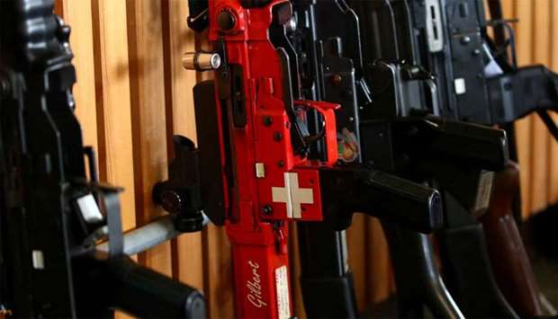 A rifle with a Swiss flag is pictured