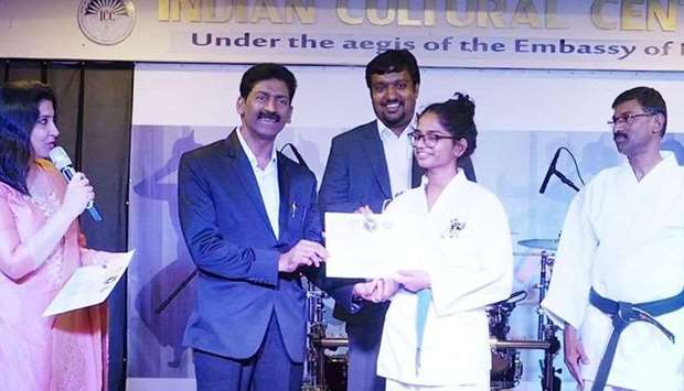 Adv. Jaffar Khan presenting a certificate to a student