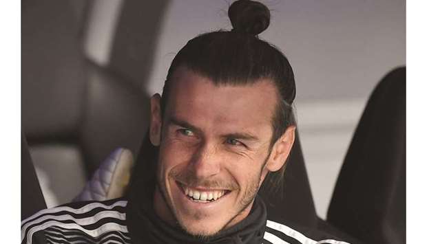 Real Madridu2019s Welsh forward Gareth Bale sits on the bench during the Spanish League football match between Real Madrid and Real Betis at the Santiago Bernabeu stadium in Madrid yesterday.
