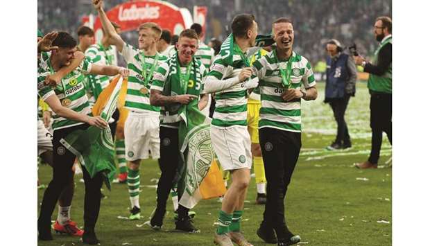 Celticu2019s Leigh Griffiths with teammates as they celebrate winning the Scottish Premier League yesterday.