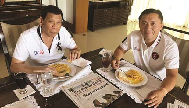 President Rodrigo Duterte and his former top aide, Christopher Lawrence Go, share a meal yesterday as rumours swirled that the chief executive was taken to a hospital after suffering a heart attack.