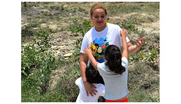 Ruth Elizabeth Gomez is received by her children near her house in Siguatepeque, Comayagua department, Honduras, after being deported from the US.