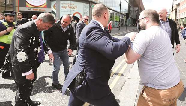 Brexit Party leader Nigel Farage gestures after being hit with a milkshake while arriving for a Brexit Party campaign event in Newcastle, Britain, yesterday.