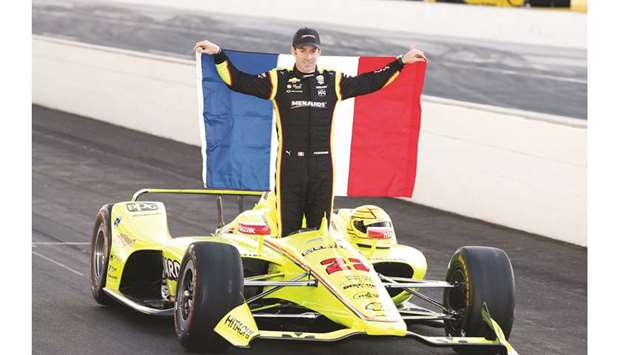 IndyCar series driver and pole sitter Simon Pagenaud poses with the French flag at Indianapolis Motor Speedway. PICTURE: USA TODAY Sports