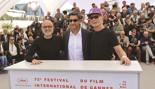 (From left) Argentinian journalist Daniel Arcucci, British director Asif Kapadia and Maradonau2019s former fitness coach Fernando Signorini pose during a photocall for the film Diego Maradona at the 72nd edition of the Cannes Film Festival. (AFP)