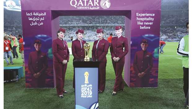 Qatar Airways air hostesses pose with the Amir Cup trophy.