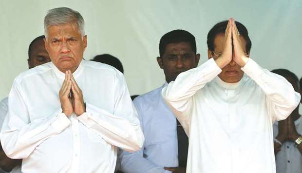 Sri Lankau2019s President Maithripala Sirisena, right, and Prime Minister Ranil Wickremesinghe attend a commemoration ceremony to mark the 26th anniversary of the assassination of Sri Lankau2019s then-president Ranasinghe Premadasa, in Colombo yesterday.
