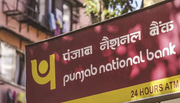 Signage for Punjab National Bank is displayed outside a branch in Mumbai. The bank is looking to merge with two or three government-owned banks that could include Oriental Bank Of Commerce, Andhra Bank and Allahabad Bank, sources familiar with the situation said yesterday.