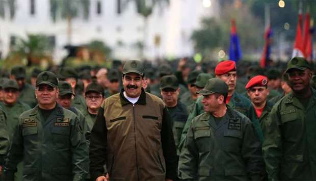 Venezuela's President Nicolas Maduro (C) with military troops accompanied by Defense Minister Vladimir Padrino (L) at the ,Fuerte Tiuna, in Caracas