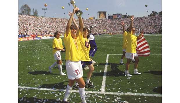 In this July 10, 1999, picture, Julie Foudy (centre) of the US holds up the FIFA Womenu2019s World Cup trophy after the win over China in the final in Pasadena, California. (Reuters)