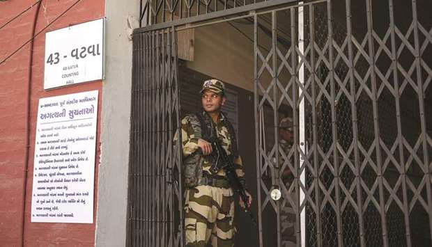 A paramilitary soldier from the Central Industrial Security Force (CISF) stands guard at a counting centre in Ahmedabad yesterday.