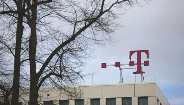 The T-Mobile logo is seen on top of the Deutsche Telekom headquarters in Bonn. While the US Justice Department staff balked at T-Mobileu2019s  $26bn acquisition of smaller rival Sprint Corp, the Federal Communications Commission indicated that it had reached an agreement in principle with the companies to allow the deal after the companies agreed to sell Sprintu2019s prepaid brand Boost Mobile.