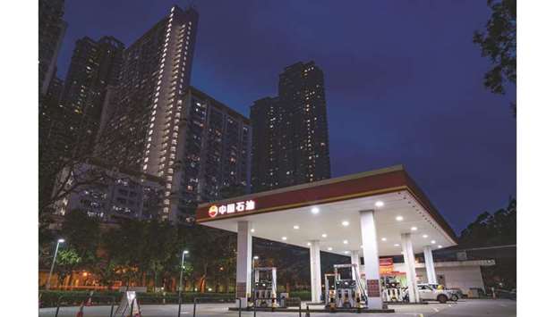 A PetroChina gas station stands at night in Hong Kong. The company is bucking normal practice and raising its wholesale natural gas prices during the weak-demand spring season, several sources said, preparing for the coming consolidation of Chinau2019s pipeline assets and trying to recoup huge fuel import losses.