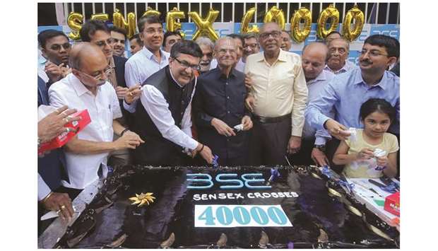Ashishkumar Chauhan, MD and CEO of the Bombay Stock Exchange, poses as he cuts a cake to celebrate the Sensex rising to over 40,000 in Mumbai yesterday.