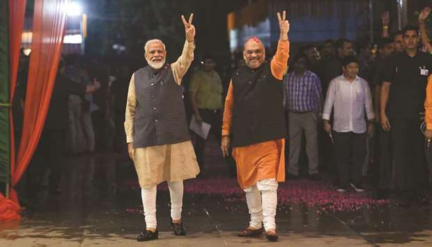Prime Minister Narendra Modi and president of the ruling Bharatiya Janata Party (BJP) Amit Shah gesture as they celebrate the victory in the general elections in New Delhi yesterday.