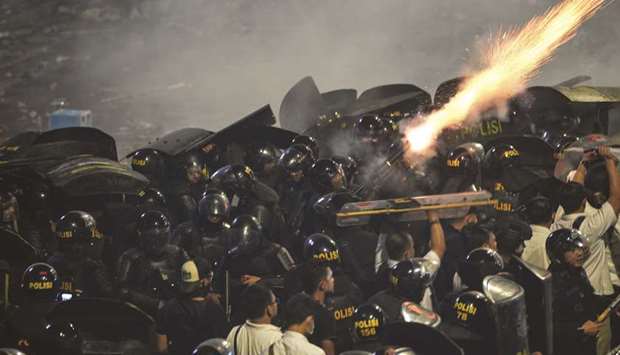 Police fire tear gas at protesters in Jakarta.