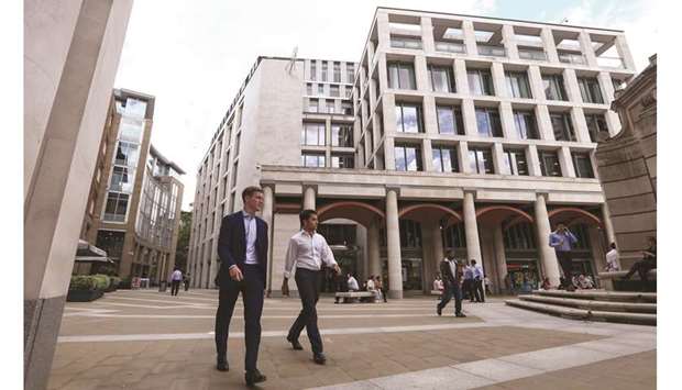 Pedestrians pass the London Stock Exchange Group offices in Paternoster Square. The FTSE 100 closed 1.4% down at 7,231.04 points yesterday.