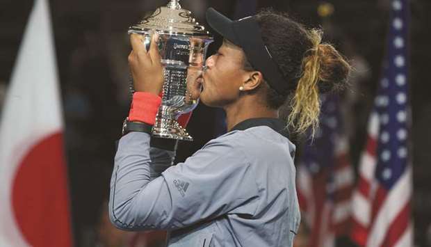 In this September 9, 2018, picture, Naomi Osaka of Japan kisses the US Open womenu2019s singles winneru2019s trophy after beating Serena Williams of the US. (AFP)