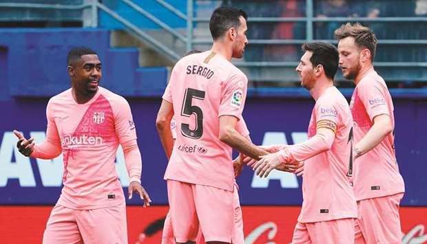 Barcelonau2019s Argentinian forward Lionel Messi (second right) celebrates with teammates after scoring a goal against Eibar during the La Liga match in Eibar on Sunday. (AFP)