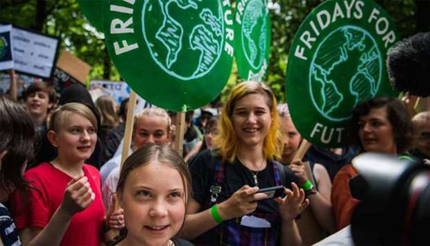 Greta Thunberg (C), the 16-year-old Swedish climate activist, marches during the ,Global Strike For Future, movement on a global day of student protests aiming to spark world leaders into action on climate change