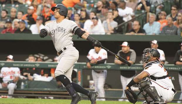 New York Yankees shortstop Thairo Estrada (left) hits a two-run home-run during the game against the Baltimore Orioles in Baltimore on Wednesday. (USA TODAY Sports)