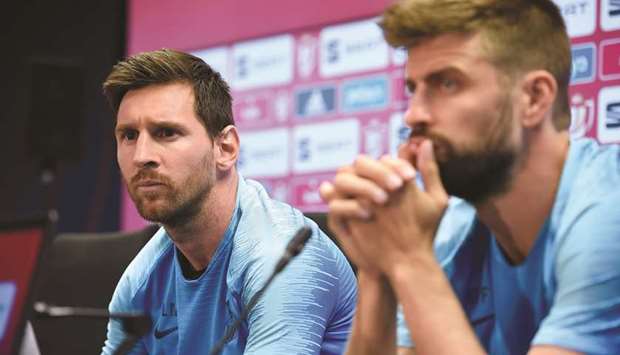 Barcelonau2019s Lionel Messi (left) and Gerard Pique hold a press conference in Barcelona yesterday on the eve of their Copa del Rey final against Valencia (AFP)