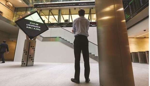 A visitor looks at a ticker of share prices at the London Stock Exchange. The FTSE 100 closed up 0.7% to 7,277.73 points yesterday.