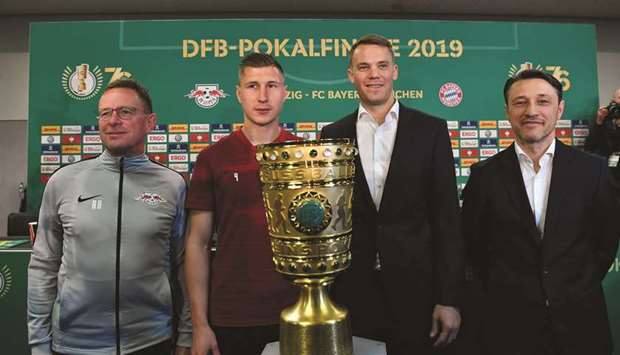 From left: RB Leipzigu2019s head coach Ralf Rangnick, defender Willi Orban, Bayern Munichu2019s goalkeeper Manuel Neuer and head coach Niko Kovac pose with the trophy after a press conference yesterday on the eve of the German Cup final at the Olympic Stadium in Berlin. (AFP)