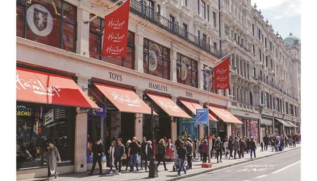 Pedestrians pass The Hamleys Group Ltd flagship store on Regent Street in London. Monthly retail sales volumes were flat last month, the Office for National Statistics said, stronger than a median forecast for a 0.3% decline in a Reuters poll of economists.