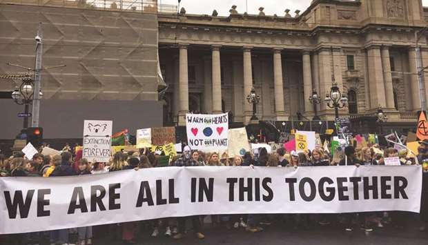 People at a rally led by Extinction Rebellion, call for action on climate change, in Melbourne, Australia.