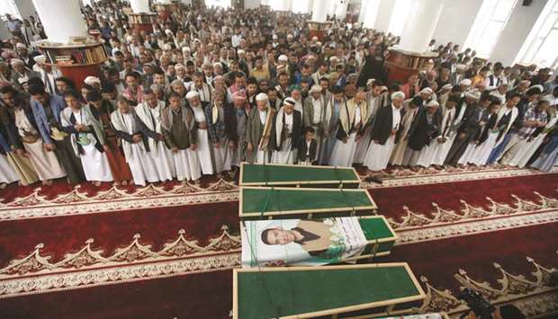Mourners attend a funeral of people, who were killed by an air strike launched by the Saudi-led coalition in Sanaa, yesterday.