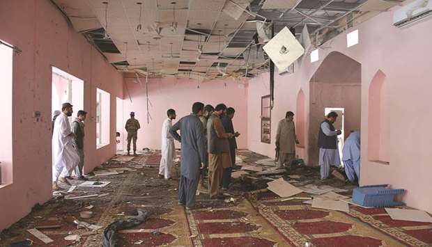 Security officials examine the interior of the mosque in Quetta following the blast.