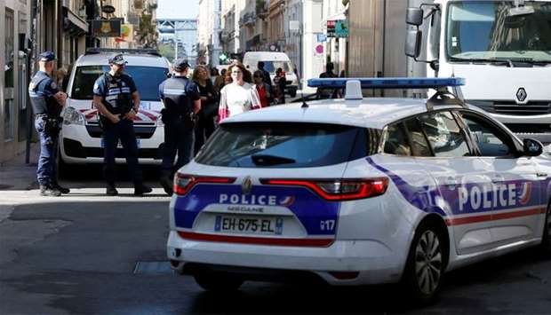 Police patrol the streets during the manhunt of a suspected suitcase bomber in central Lyon