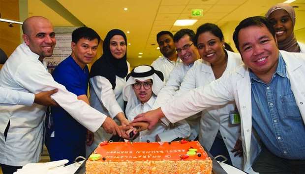 Abdulrahman Shahin al-Neimi and members of his care team.rnrn