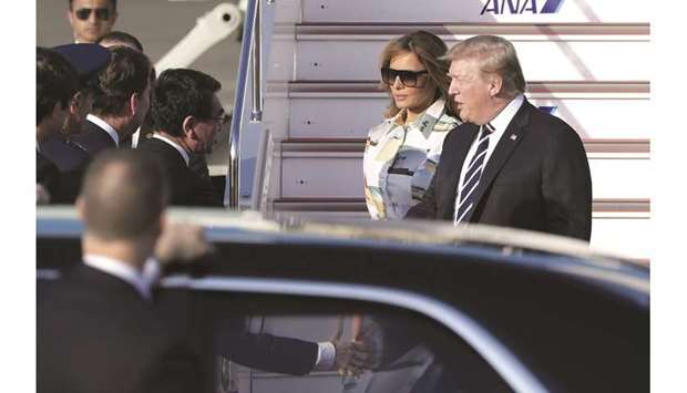 US President Donald Trump (right) and First Lady Melania Trump (second right) are greeted by Taro Kono,  Japanu2019s foreign minister, after disembarking from Air Force One as they arrive at Haneda Airport in Tokyo. Trump is the first foreign leader to be invited to Japan for a state visit since Emperor Naruhito took the throne on May 1.
