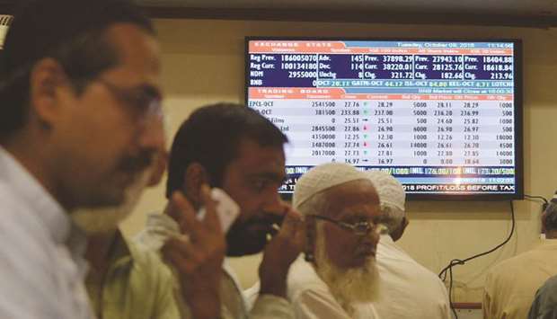 Pakistani stockbrokers watch share prices on their monitors during a trading session at the Pakistan Stock Exchange in Karachi. The benchmark index of the PSX gained 2,537 points last week, recovering by 7.5% since fluctuations in the exchange rate and economic uncertainty wreaked havoc in the financial markets.