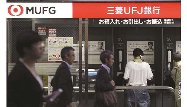 Customers use automated teller machines at a MUFG Bank branch in Tokyo. MUFG enlisted Cantor Fitzgerald LP to help sell bonds from the oil and gas exploration firm CNX Resources Corp, according to people familiar with the matter.