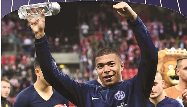 Paris Saint-Germainu2019s French forward Kylian Mbappe holds u2018best strikeru2019 trophy at the end of the French L1 match against Reims at the Auguste-Delaune Stadium in Reims. (AFP)