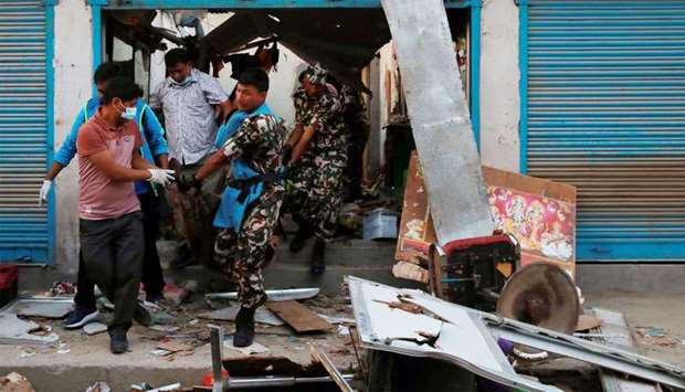 Security personnel carry a victim's body after an explosion in Kathmandu
