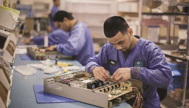 Employees at Z Microsystems assemble servers in San Diego, California (file). Fridayu2019s report showing lower capital and durable goods orders in April u2014 in addition to earlier data on retail sales, housing and manufacturing u2014 suggests the US economy is losing momentum.