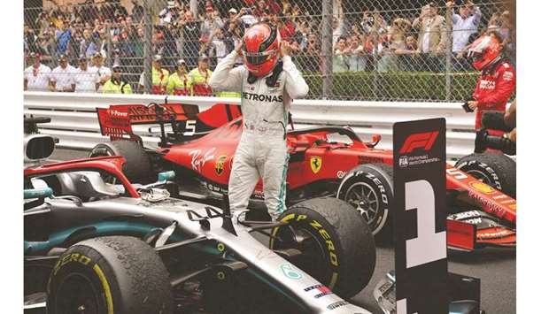 Winner Mercedesu2019 British driver Lewis Hamilton (L) takes off his helmet next to second placed Ferrariu2019s German driver Sebastian Vettel after the Monaco Formula 1 Grand Prix yesterday.