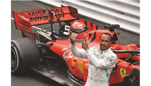 Mercedesu2019 British driver Lewis Hamilton points at the name of late Formula One legend Niki Lauda on his helmet after winning the Monaco Formula 1 Grand Prix at the Monaco street circuit yesterday.