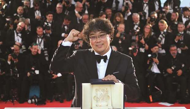 South Korean director Bong Joon-ho poses during a photocall after he won the Palme du2019Or for the film Parasite (Gisaengchung).