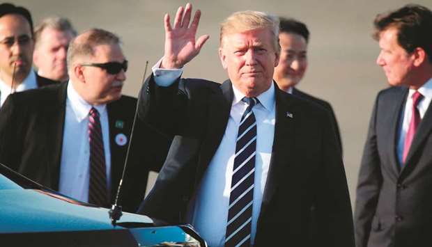 US President Donald Trump waves upon arriving at Haneda international airport in Tokyo yesterday.