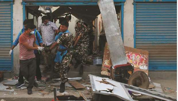 Security personnel carry a victimu2019s body after an explosion in Kathmandu yesterday.