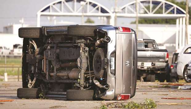 A truck lies on its side yesterday at Frontier Car Dealership after it was hit by a tornado which touched down overnight in El Reno, Oklahoma.